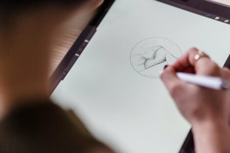 Celebrity NFT Collections Were Just Digital Pyramid Schemes for Famous People Computer screen displaying colorful digital artwork and NFT marketplace interface