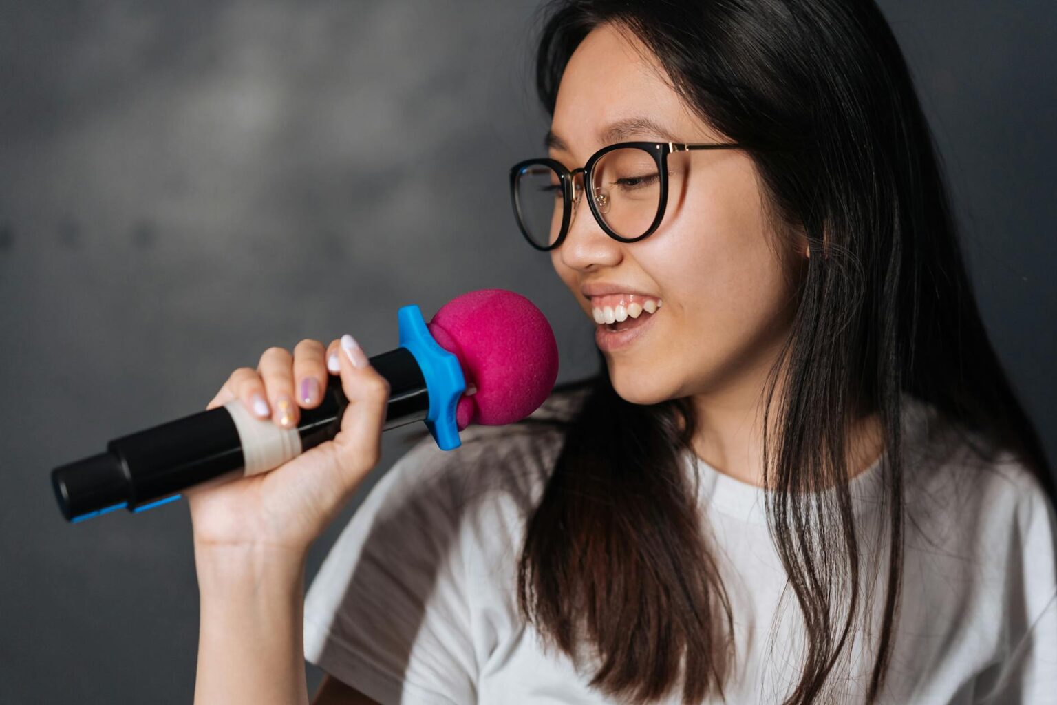 Why Major Record Labels Are Scouting Talent at Karaoke Bars Professional microphone in dimly lit karaoke venue with stage lights