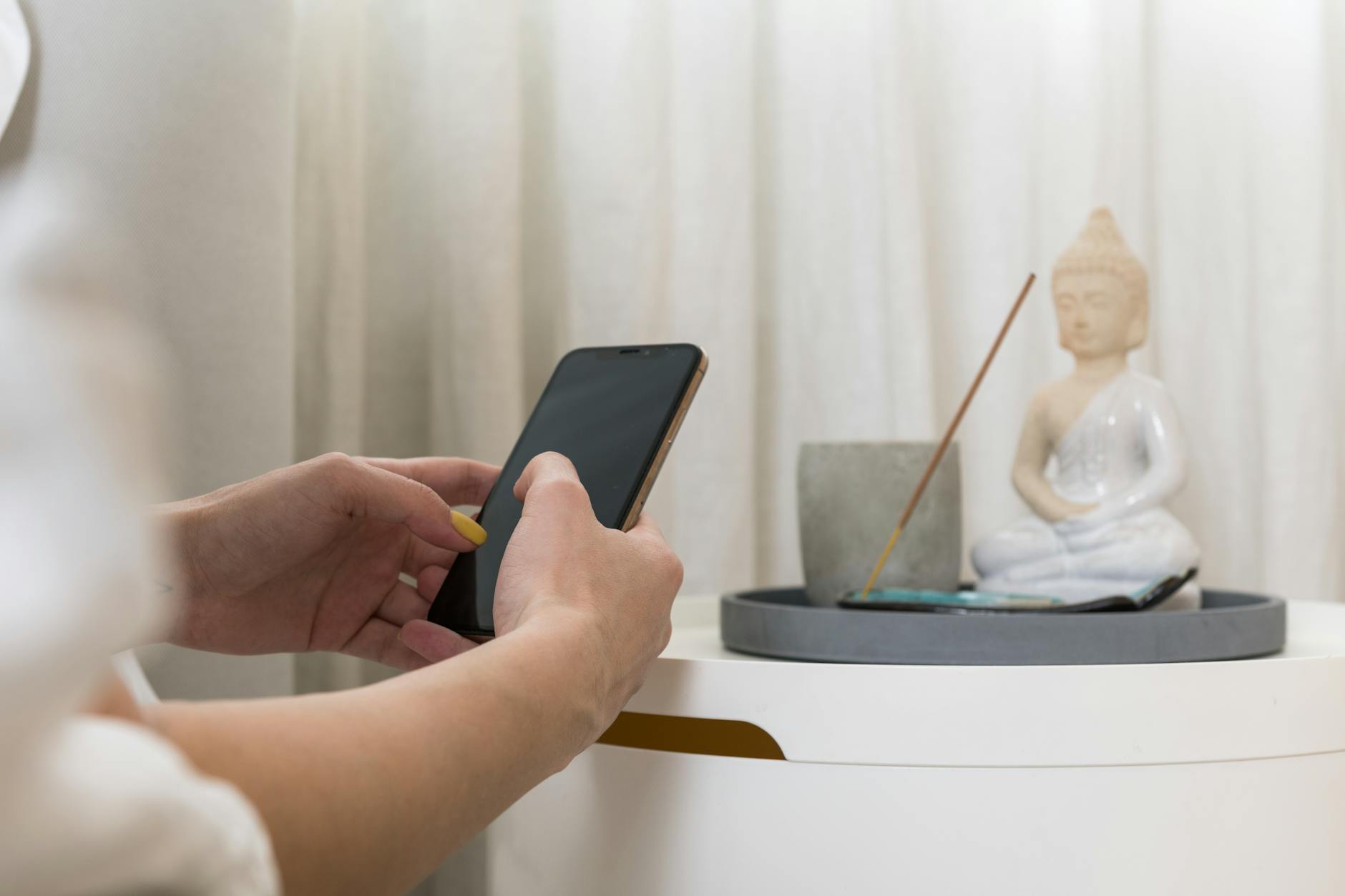 Person using smartphone with meditation app notification on screen