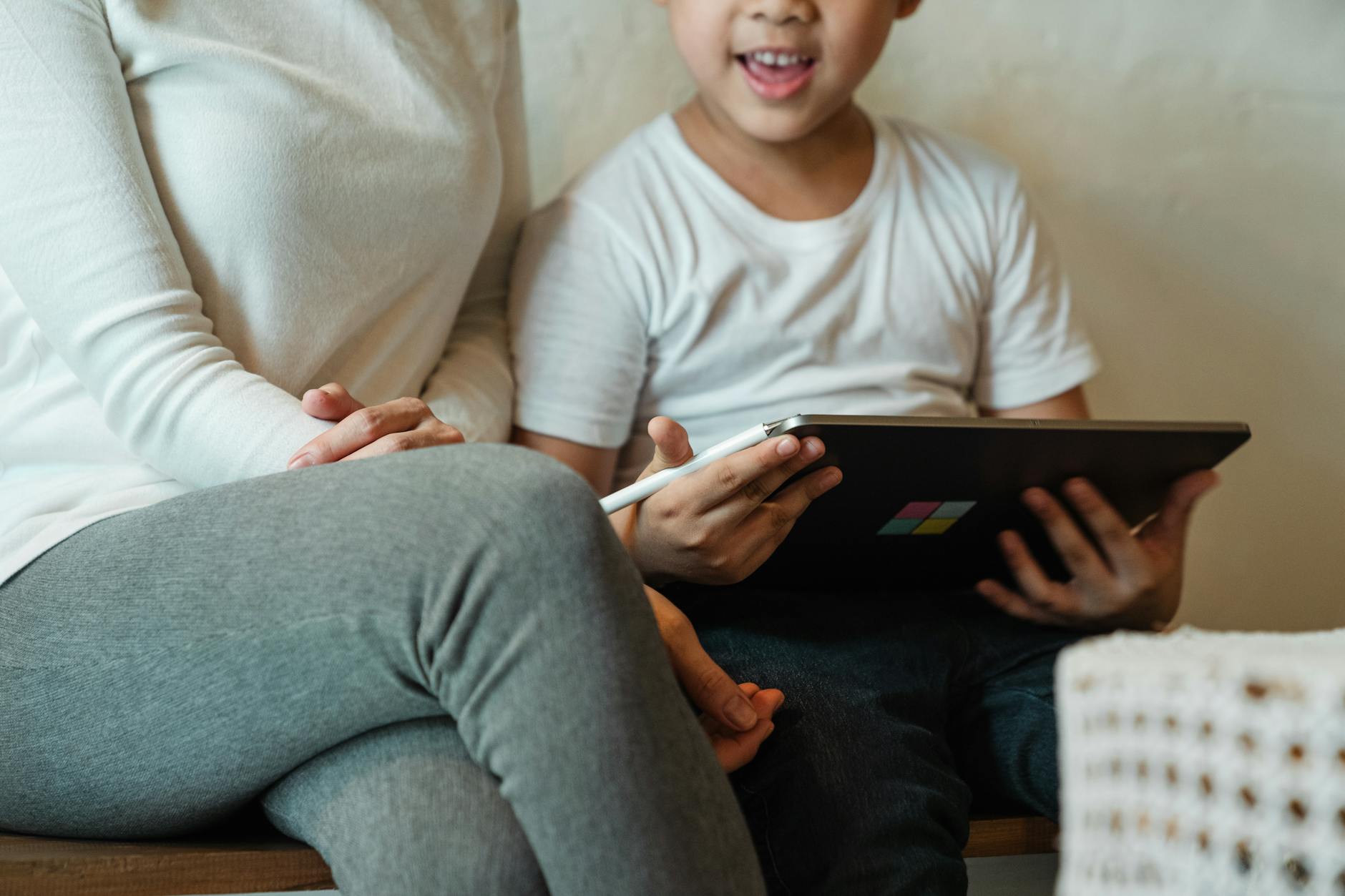 Young child looking at tablet screen in bright room
