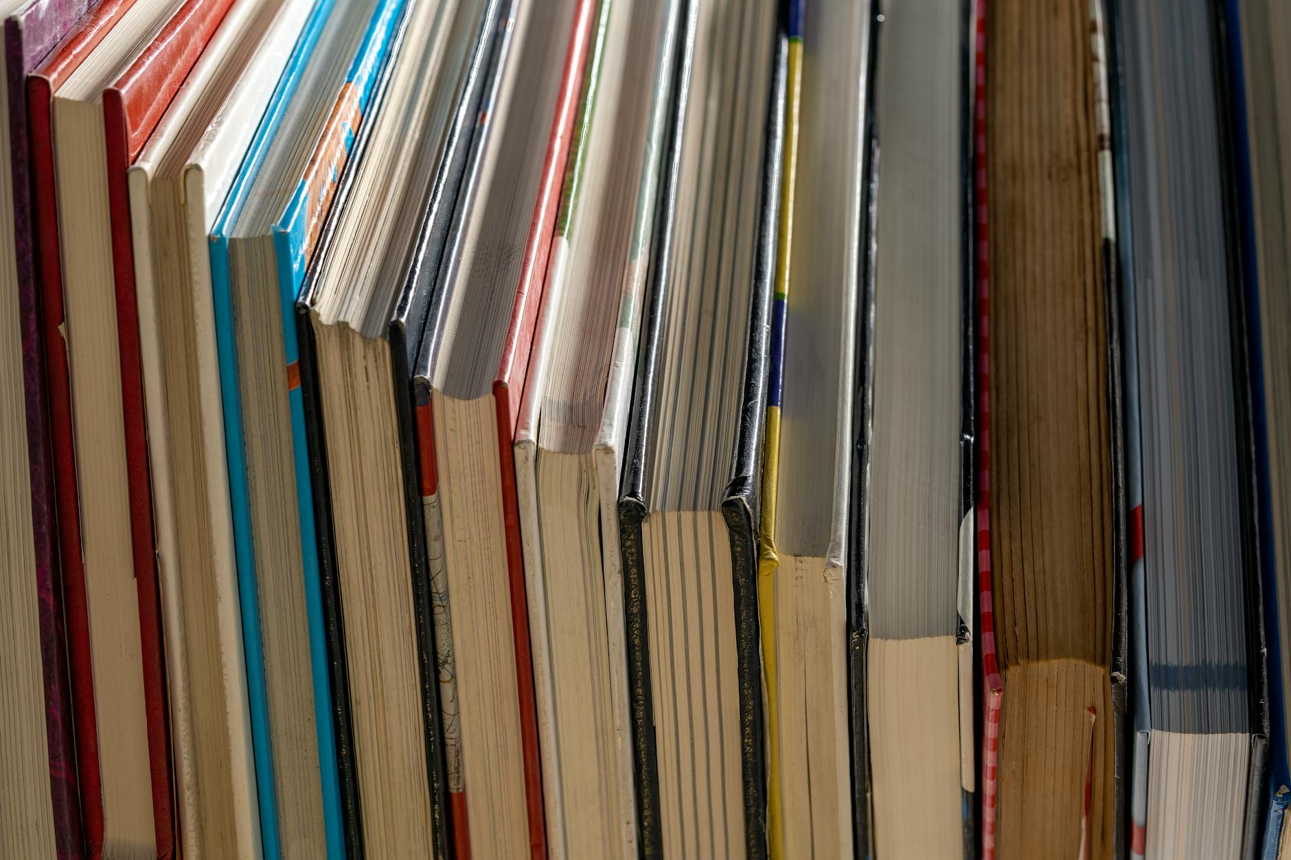 Stack of colorful books with modern cover designs arranged for social media photography