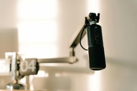 Why Podcast Hosts Are Moving Back to Traditional Radio Formats Professional radio microphone in broadcasting studio with sound equipment