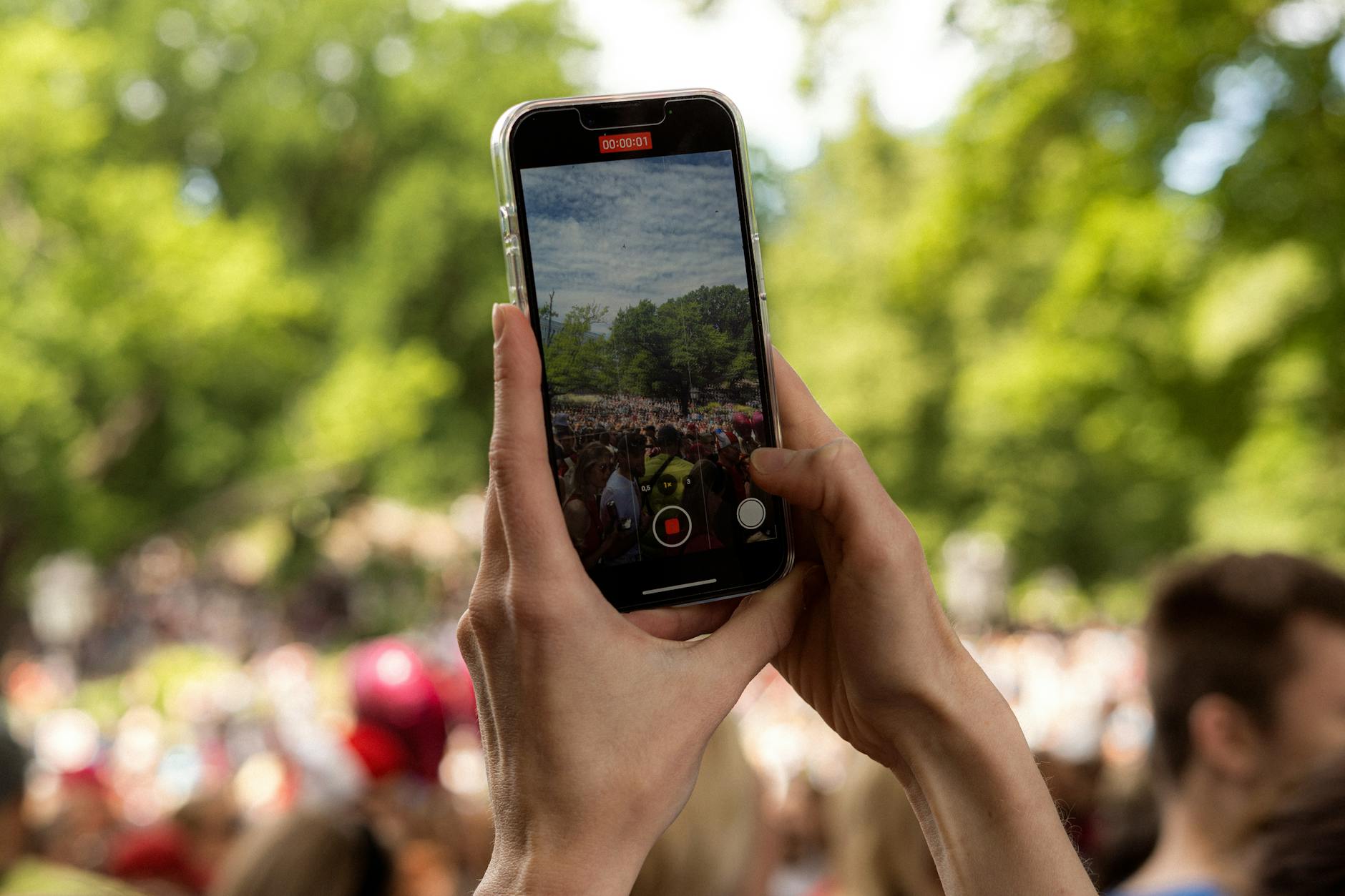 Person holding smartphone vertically to record video content