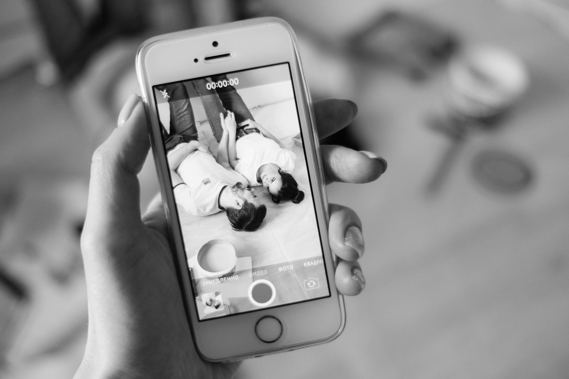 Person using dating app on smartphone, swiping through profiles