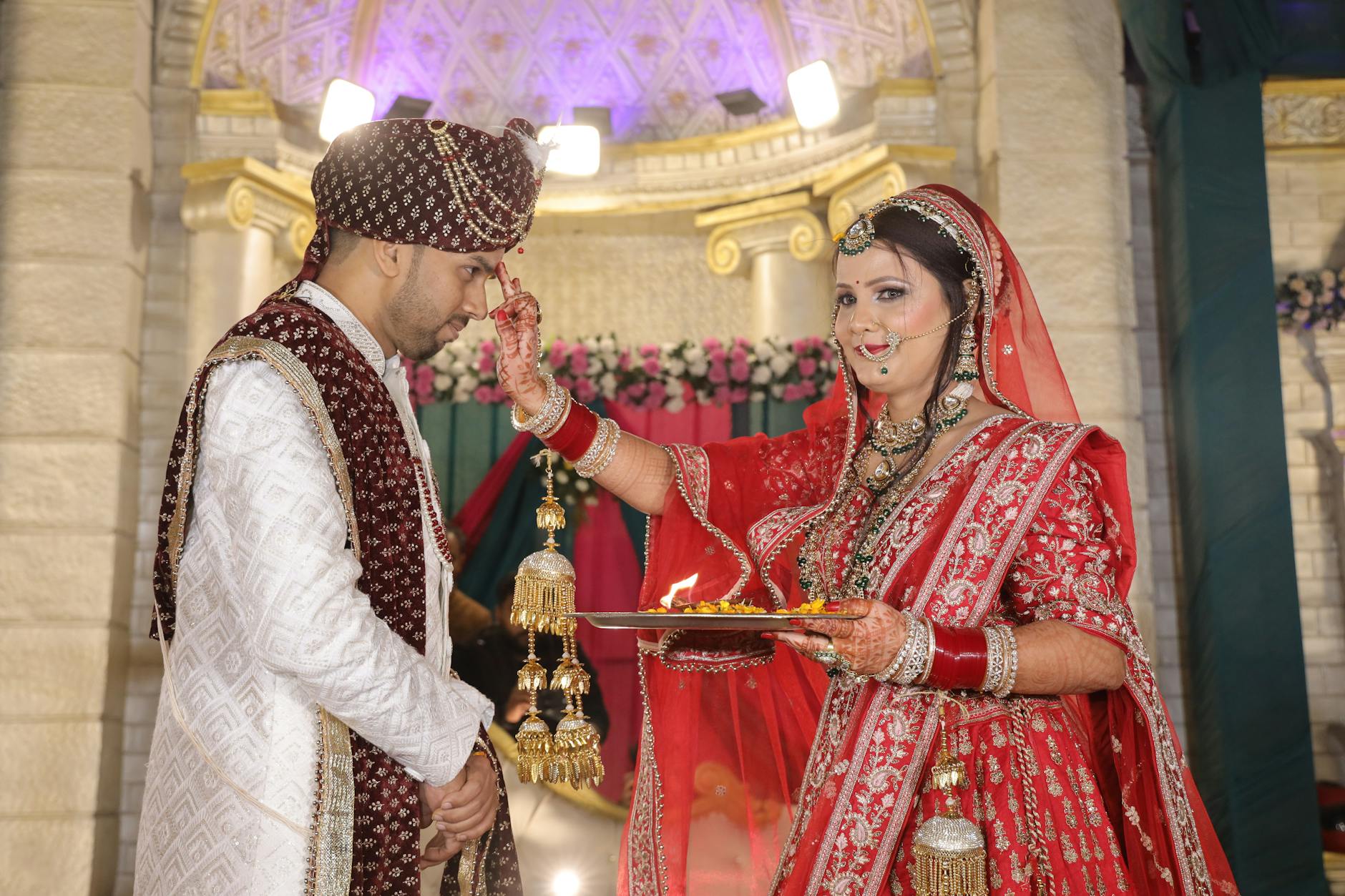 Elegant wedding ceremony with bride and groom at altar surrounded by guests in formal setting