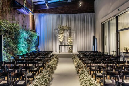 Professional photographer capturing moments at an elegant indoor wedding ceremony