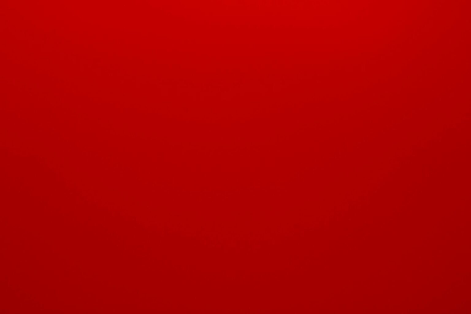 A checkered picnic blanket spread on green grass with a wicker basket