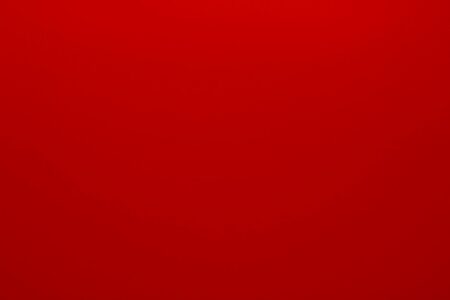 A checkered picnic blanket spread on green grass with a wicker basket