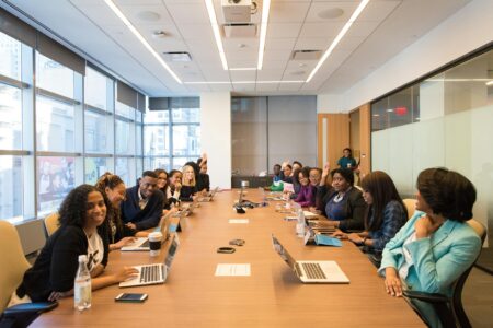 Business professionals sitting around conference table in modern office setting