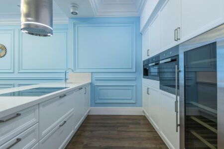 The Rise of Communal Kitchens in Expensive Urban Neighborhoods Modern communal kitchen with stainless steel appliances and large prep counters where residents can cook together