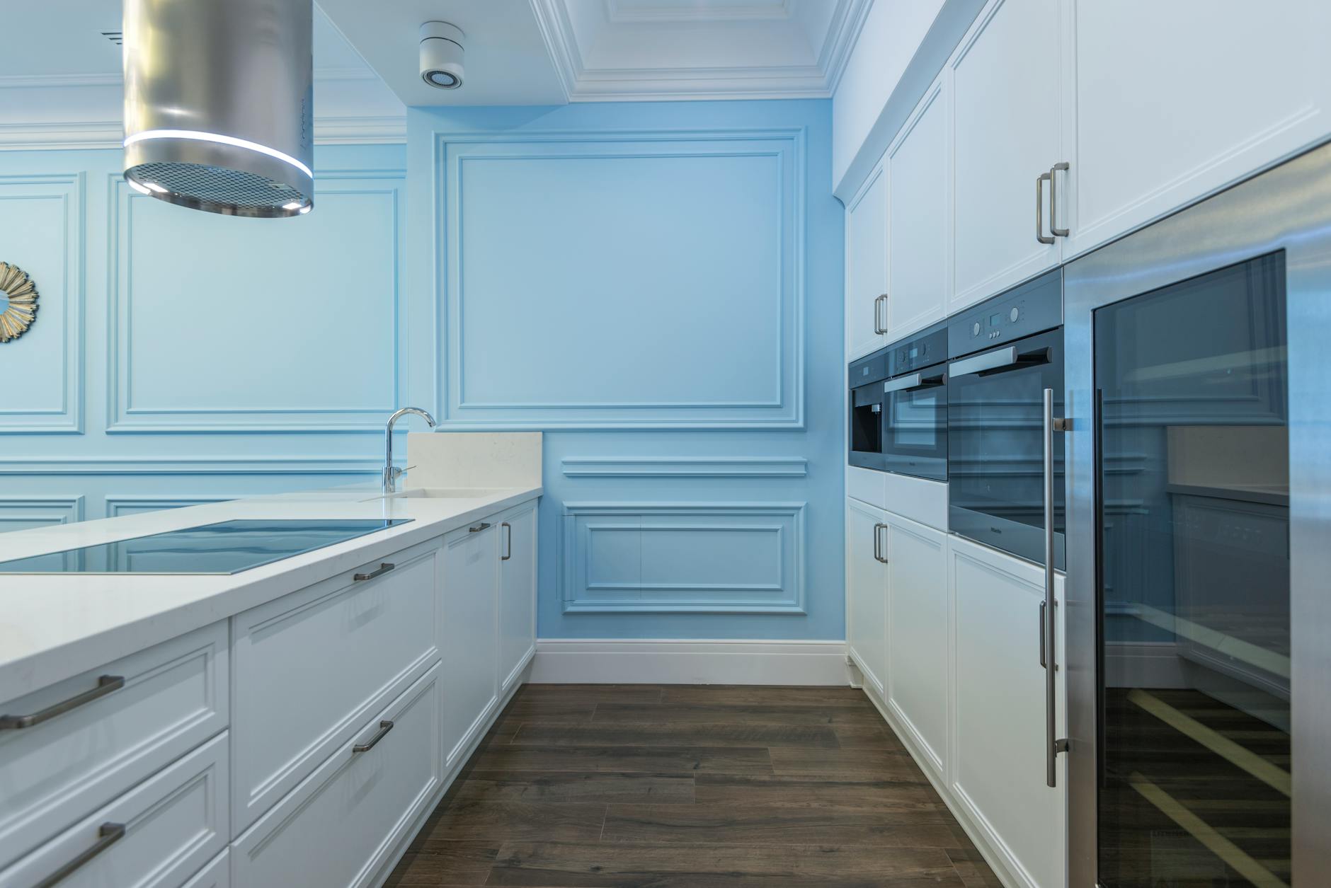 Modern communal kitchen with stainless steel appliances and large prep counters where residents can cook together