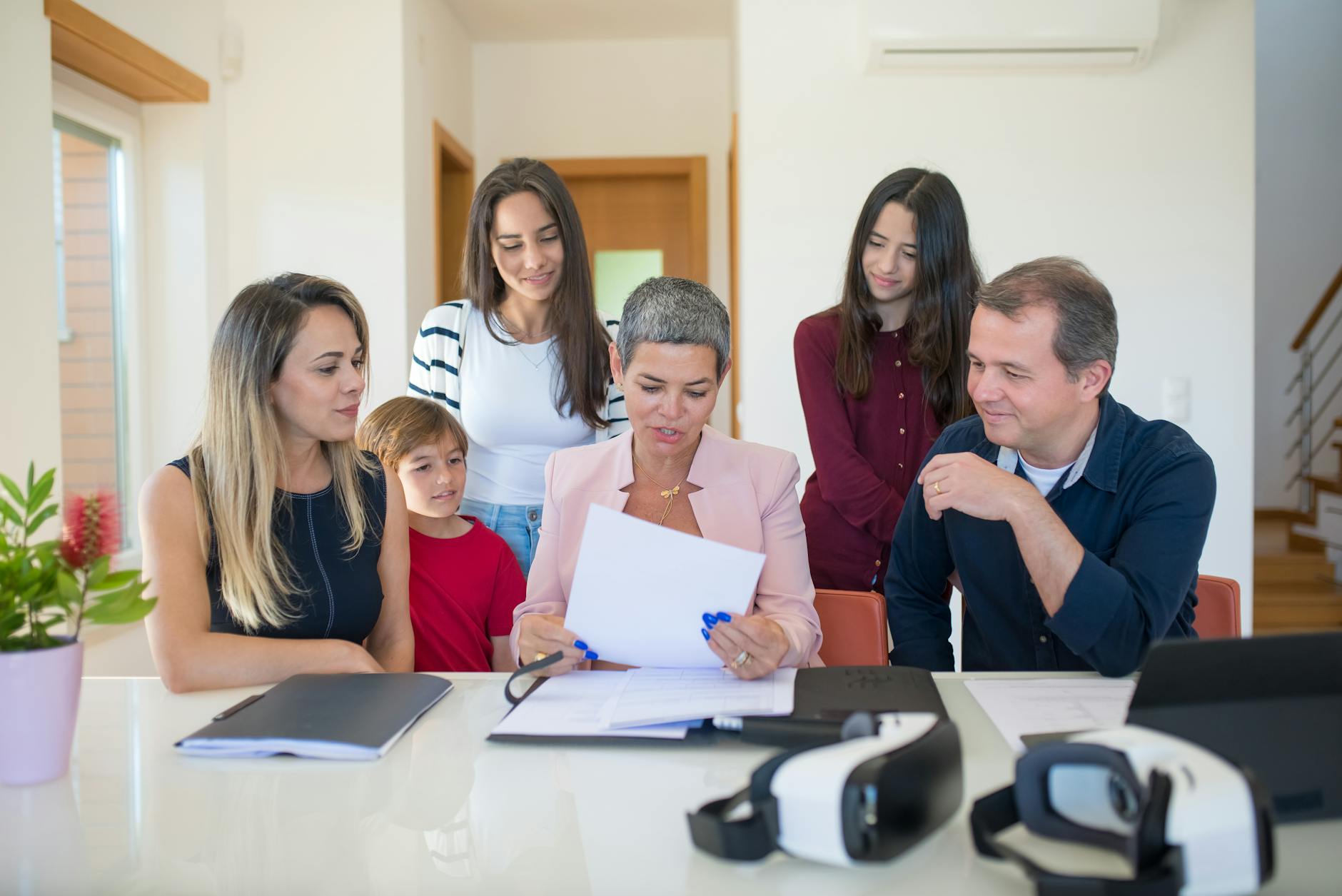 Multi-generational family having a serious discussion around a conference table