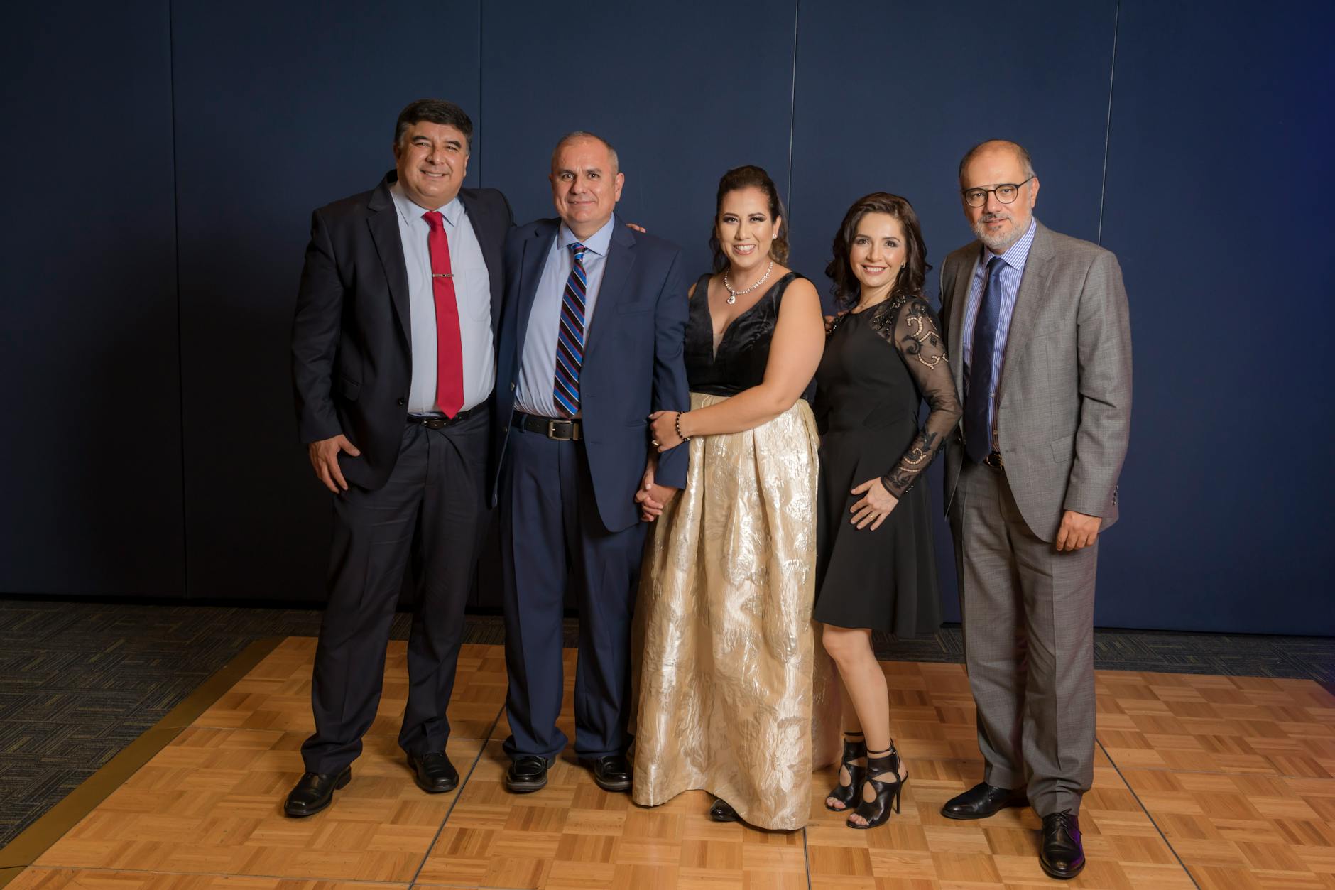 Elegant formal gala event with attendees in evening wear at decorated tables
