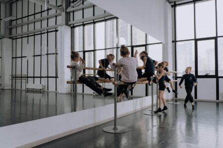 Modern dance studio with mirrors and wooden floors where K-pop choreography classes take place