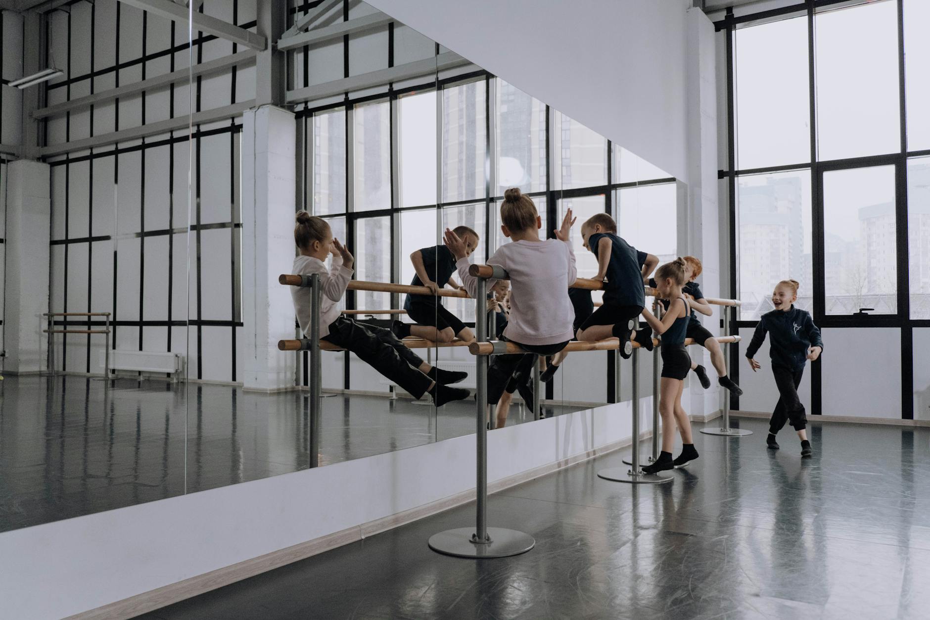 Modern dance studio with mirrors and wooden floors where K-pop choreography classes take place