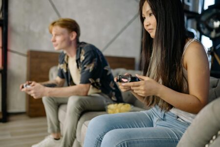 Group of friends gathered around a table playing board games in a cozy cafe setting