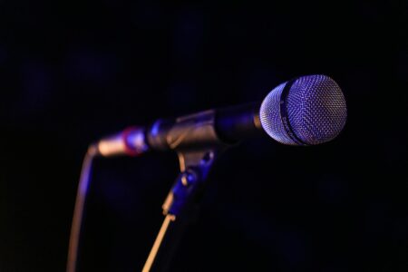 Vintage microphone on dimly lit stage with warm lighting