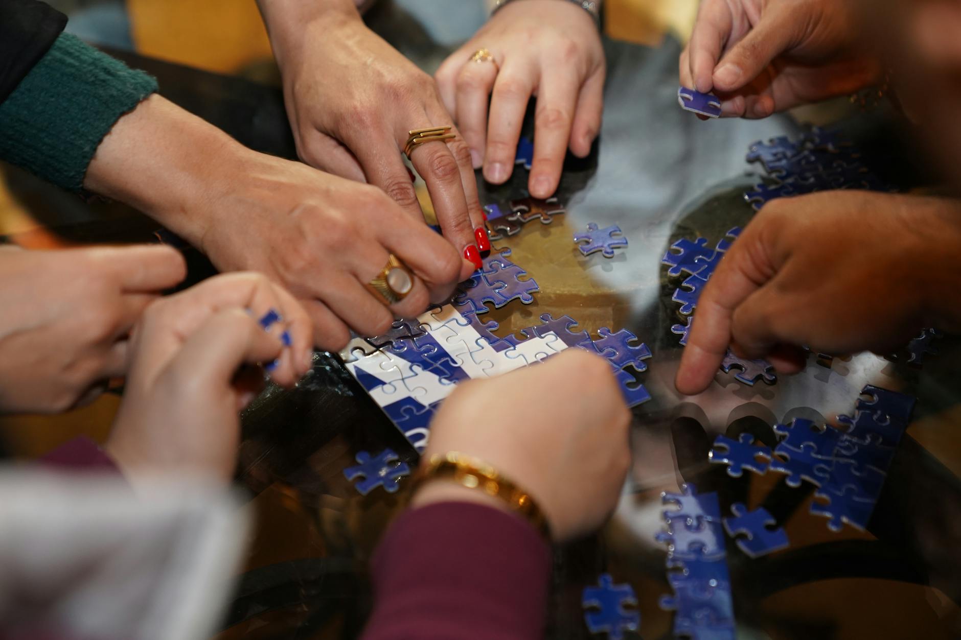 Group of people working together to solve puzzles in an escape room setting