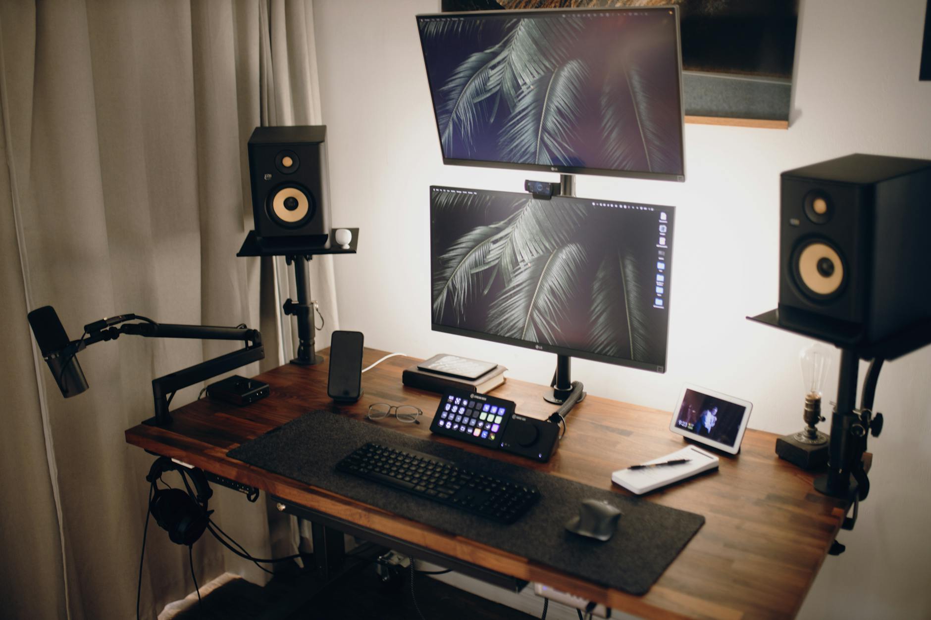 Modern streaming setup with multiple monitors, professional lighting, and gaming equipment for content creation