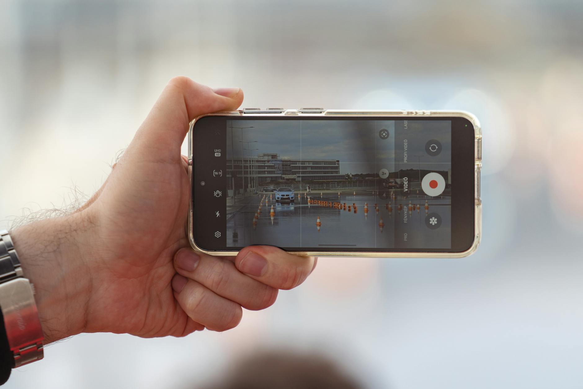 Person holding smartphone recording vertical video content