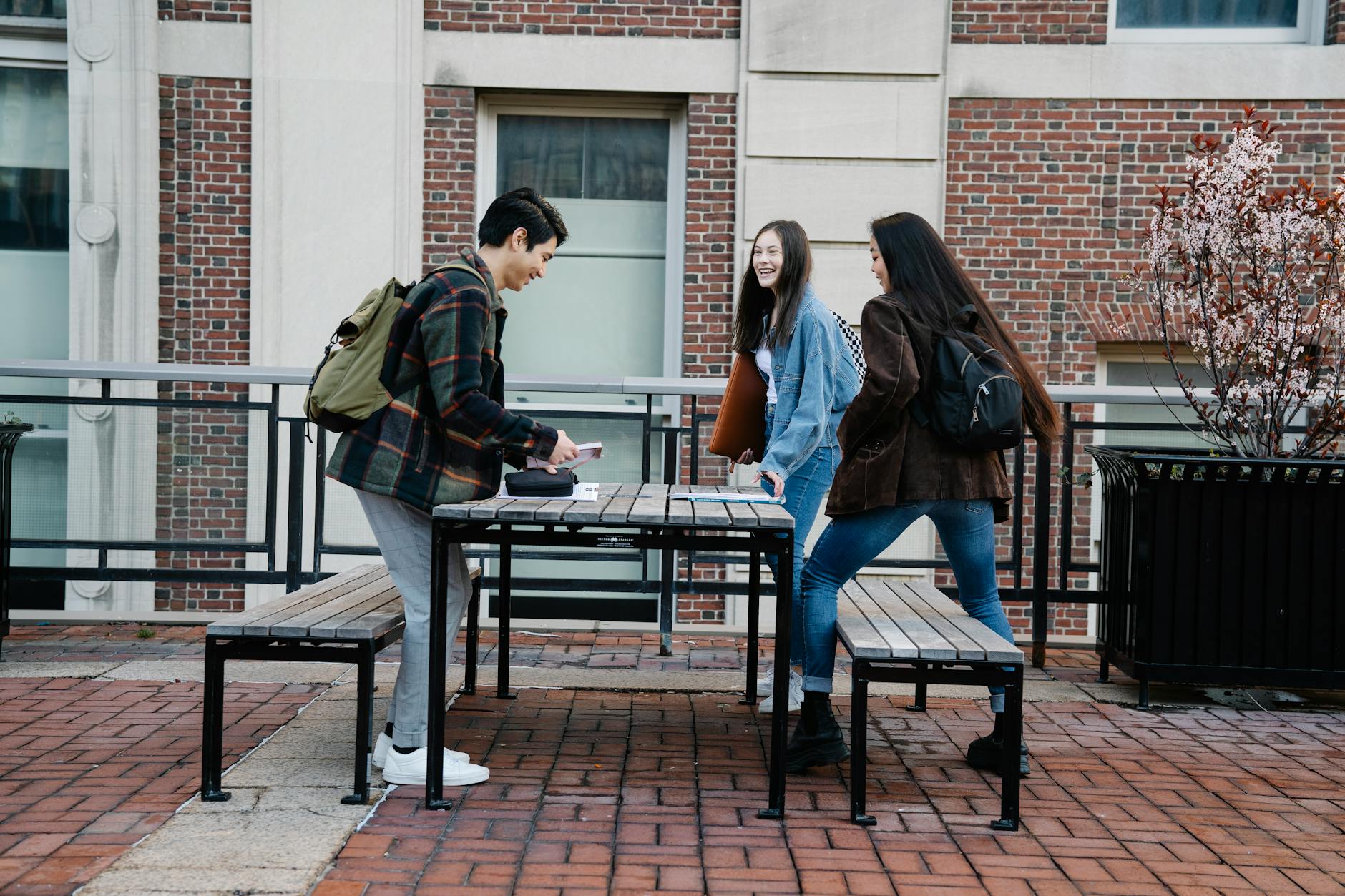 Young college students sitting together with phones, showing modern digital communication habits