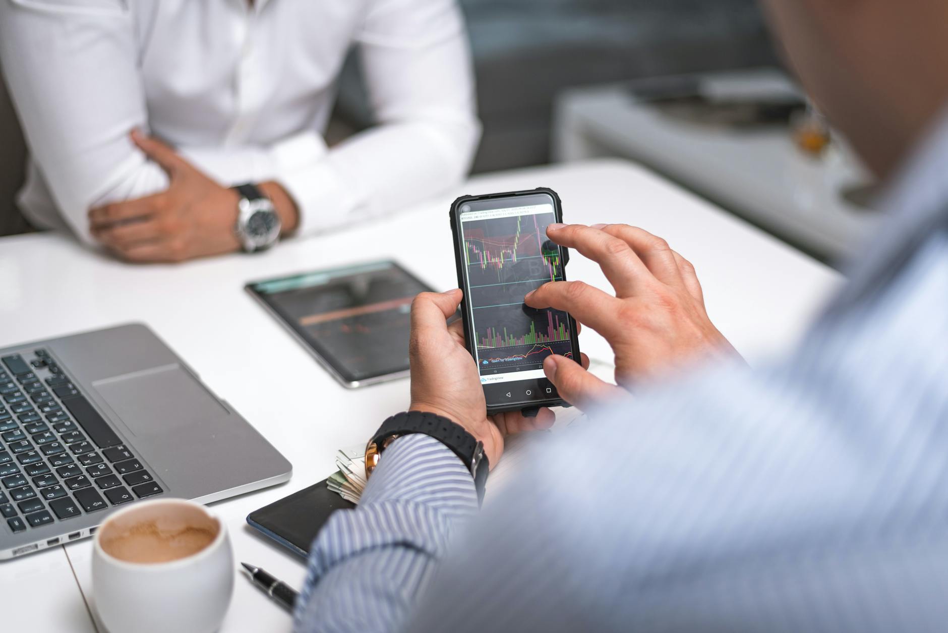 Smartphone displaying data analytics dashboard with charts and graphs on screen