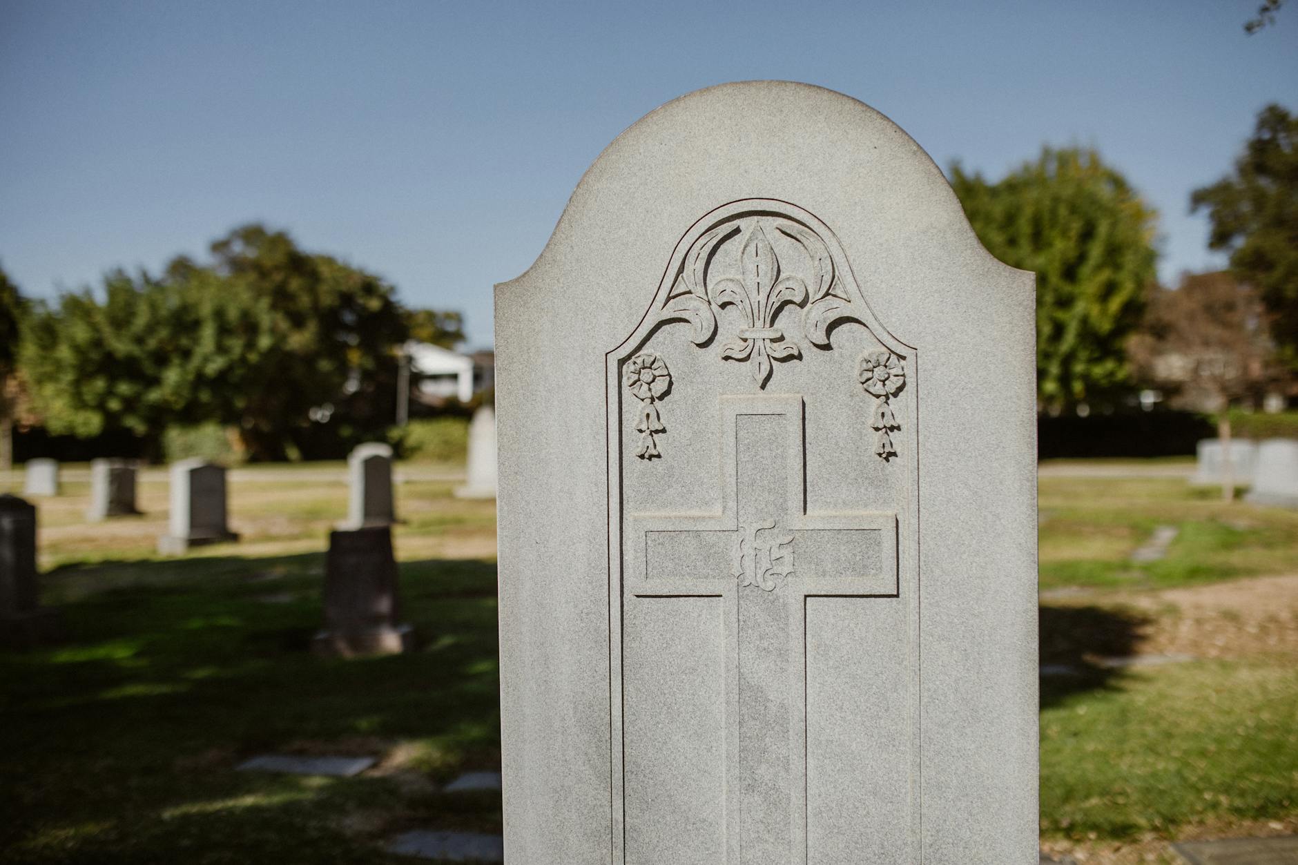 Weathered stone monuments and headstones in a historic cemetery setting