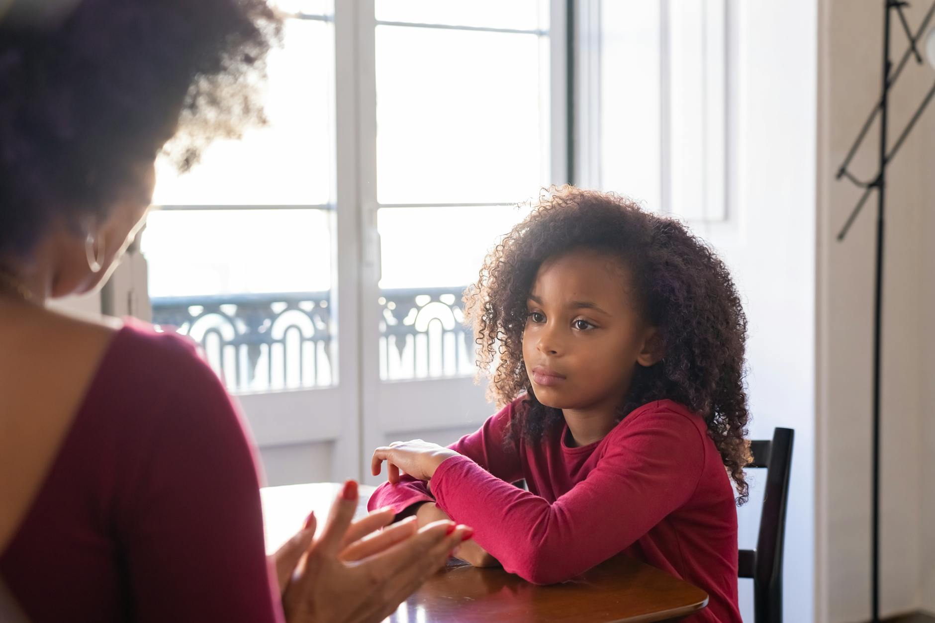 Parent and child having a serious conversation at home