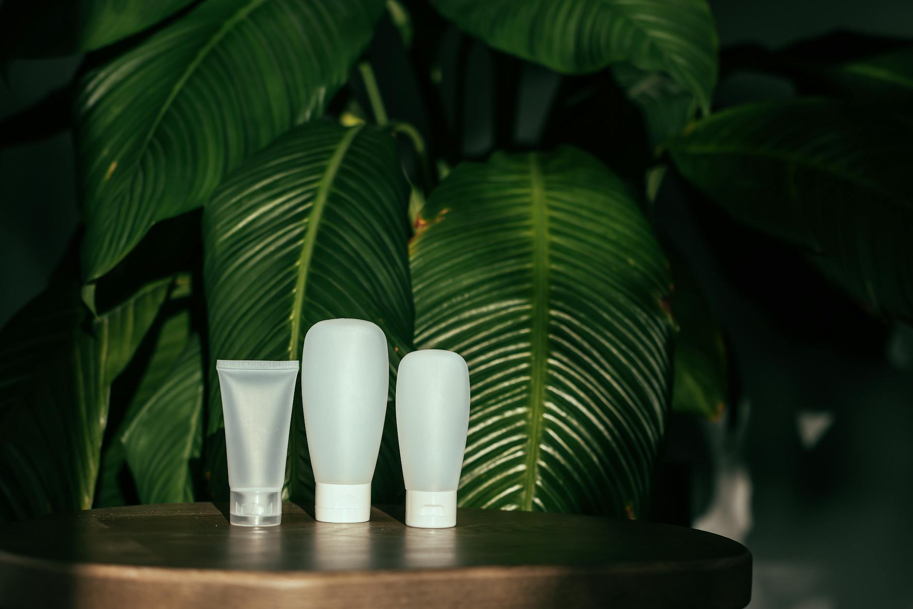 Various skincare products and beauty items arranged on a clean white surface