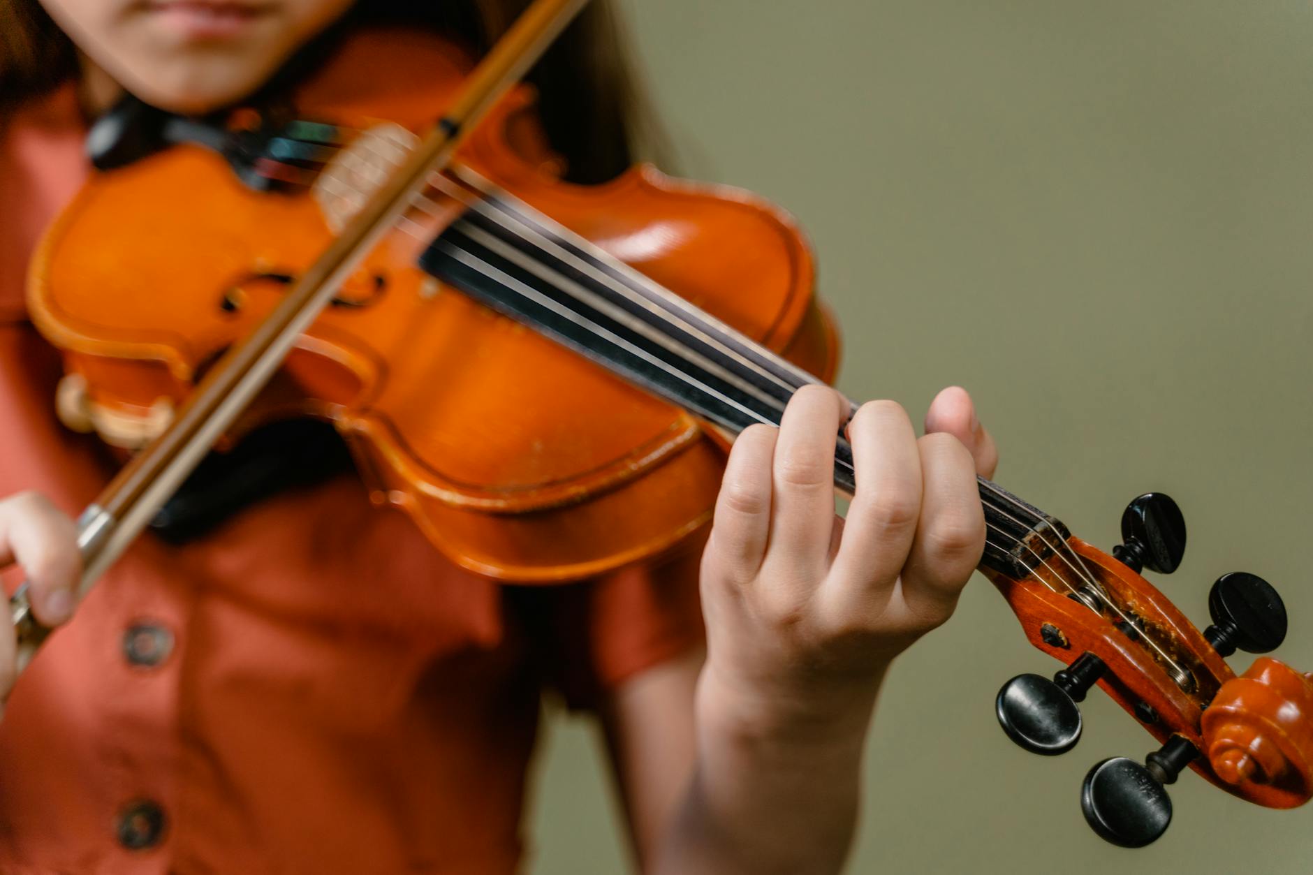 Young child playing with colorful toy musical instruments