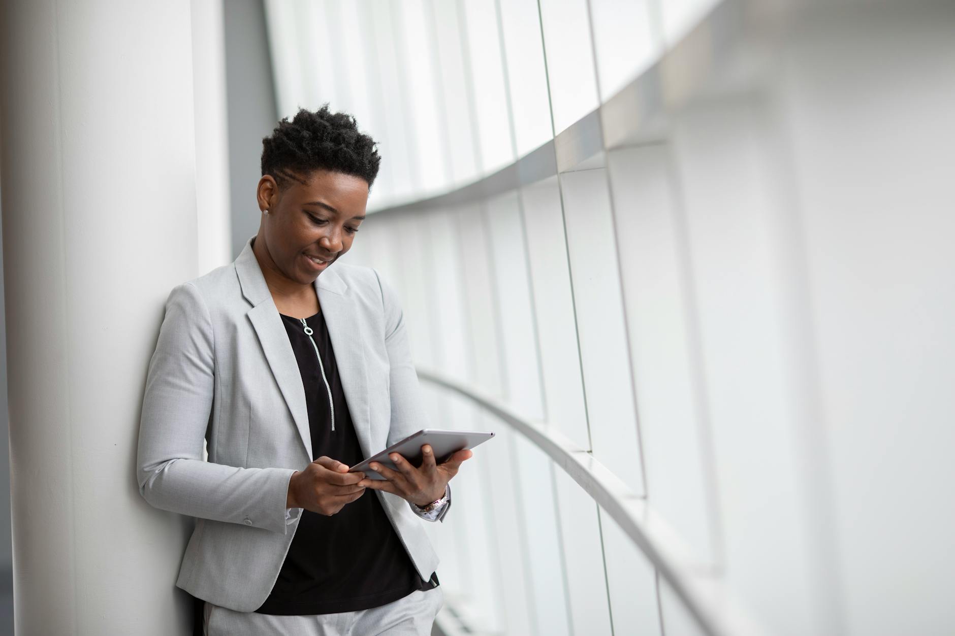 Professional woman using tablet for scheduling and coordination work