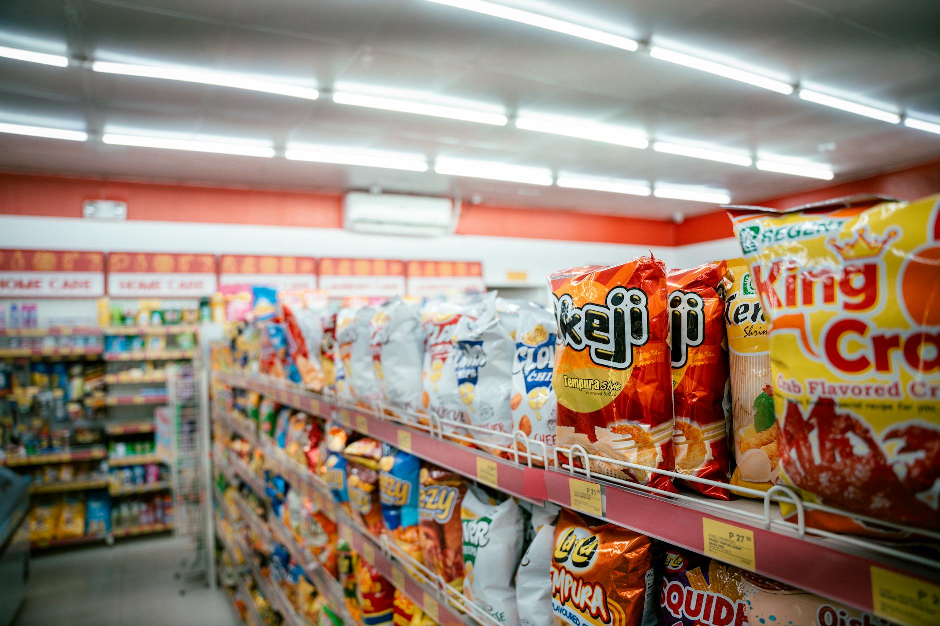 Traditional grocery store aisle with shelves stocked with packaged foods and products