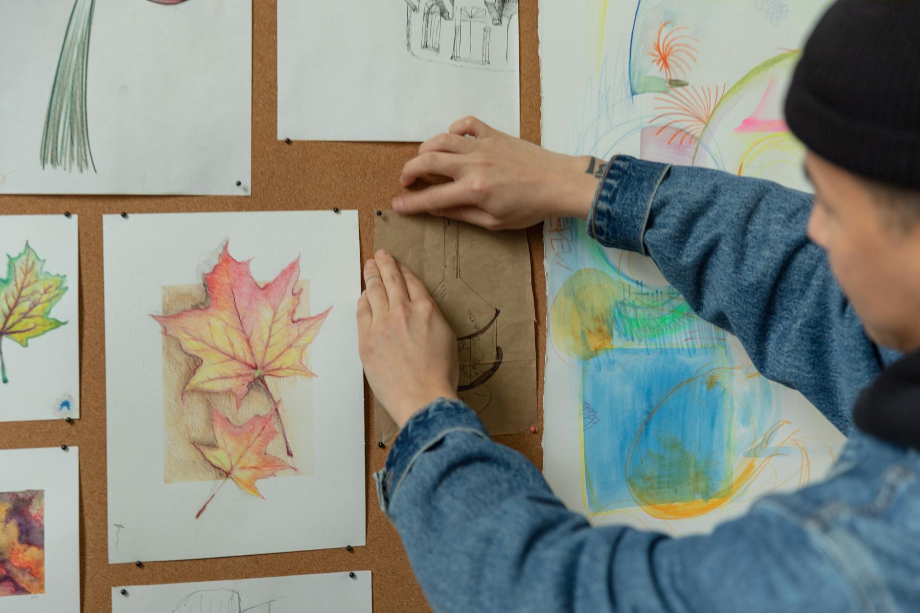 Artist's portfolio with sketches and drawings spread out on a table for review