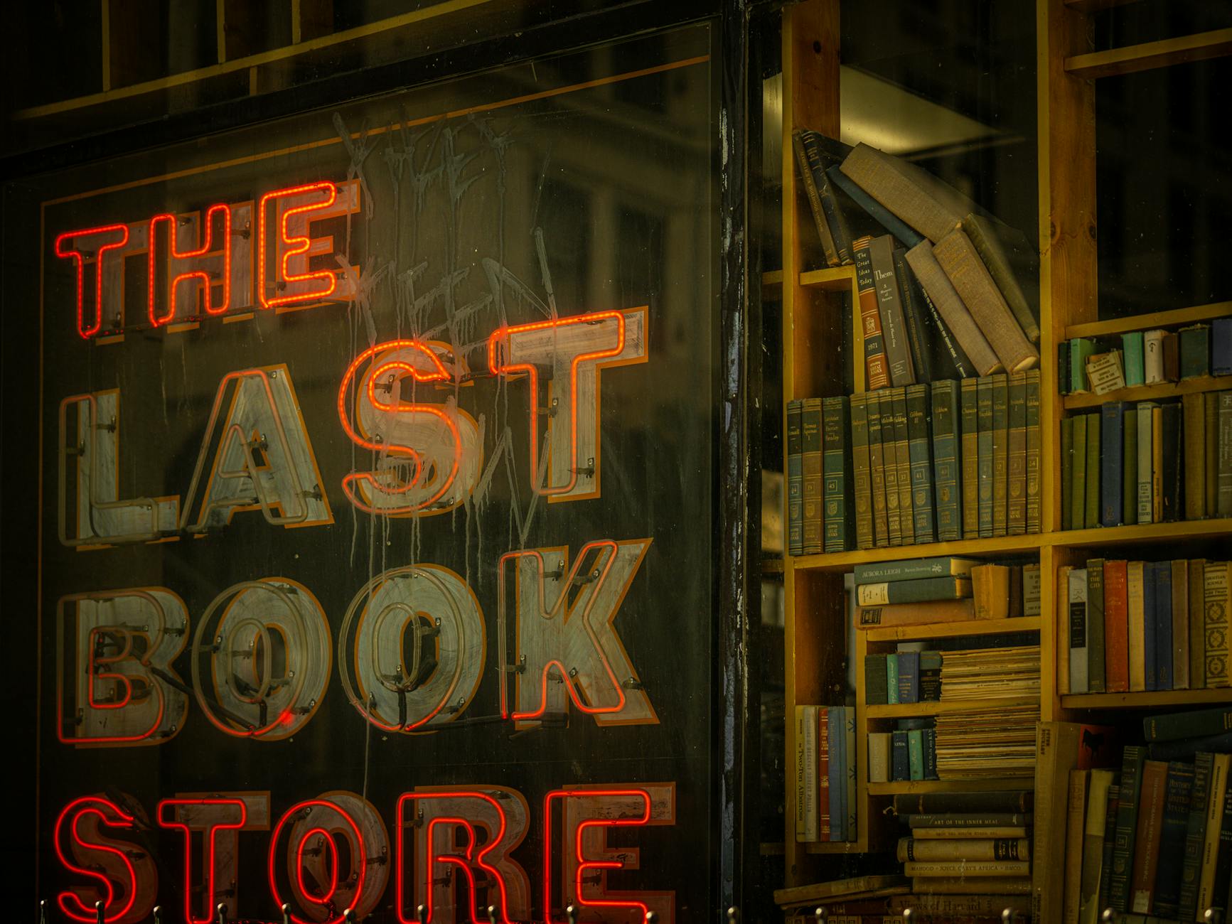 Library or bookstore shelves displaying various books and publications