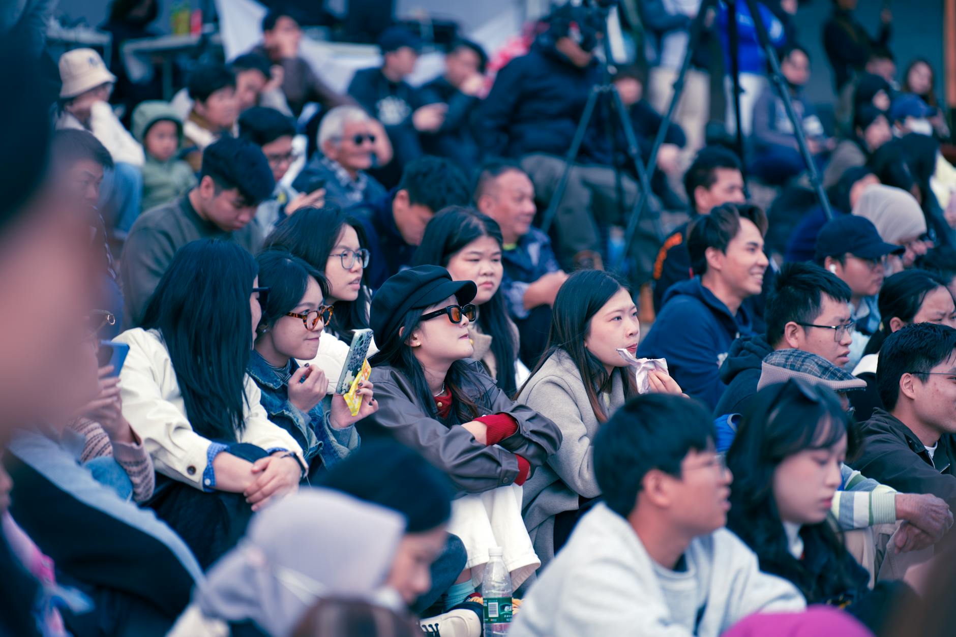 Diverse group of young people listening attentively at indoor event