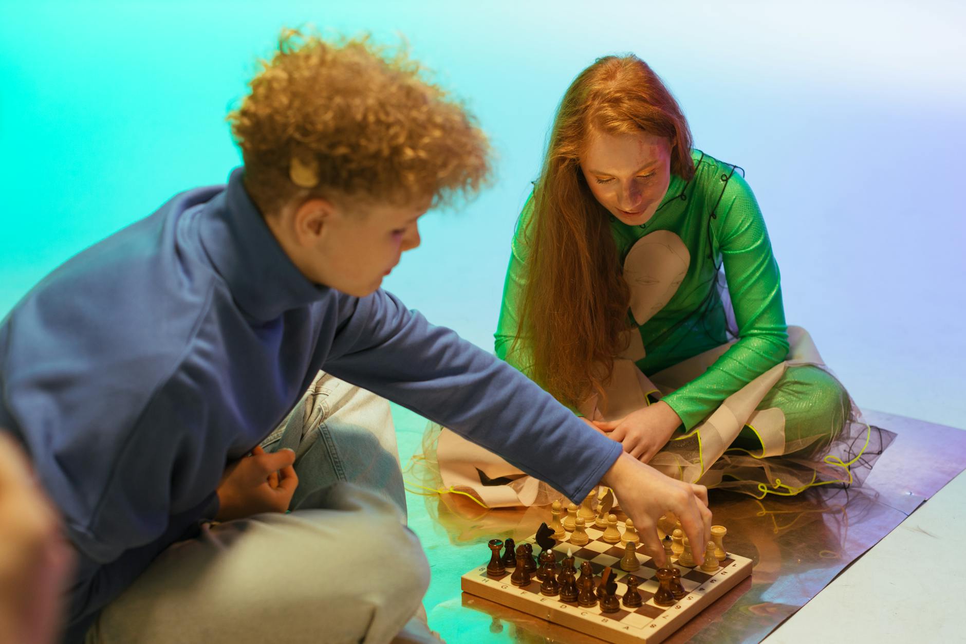 Diverse group of people playing chess in community setting
