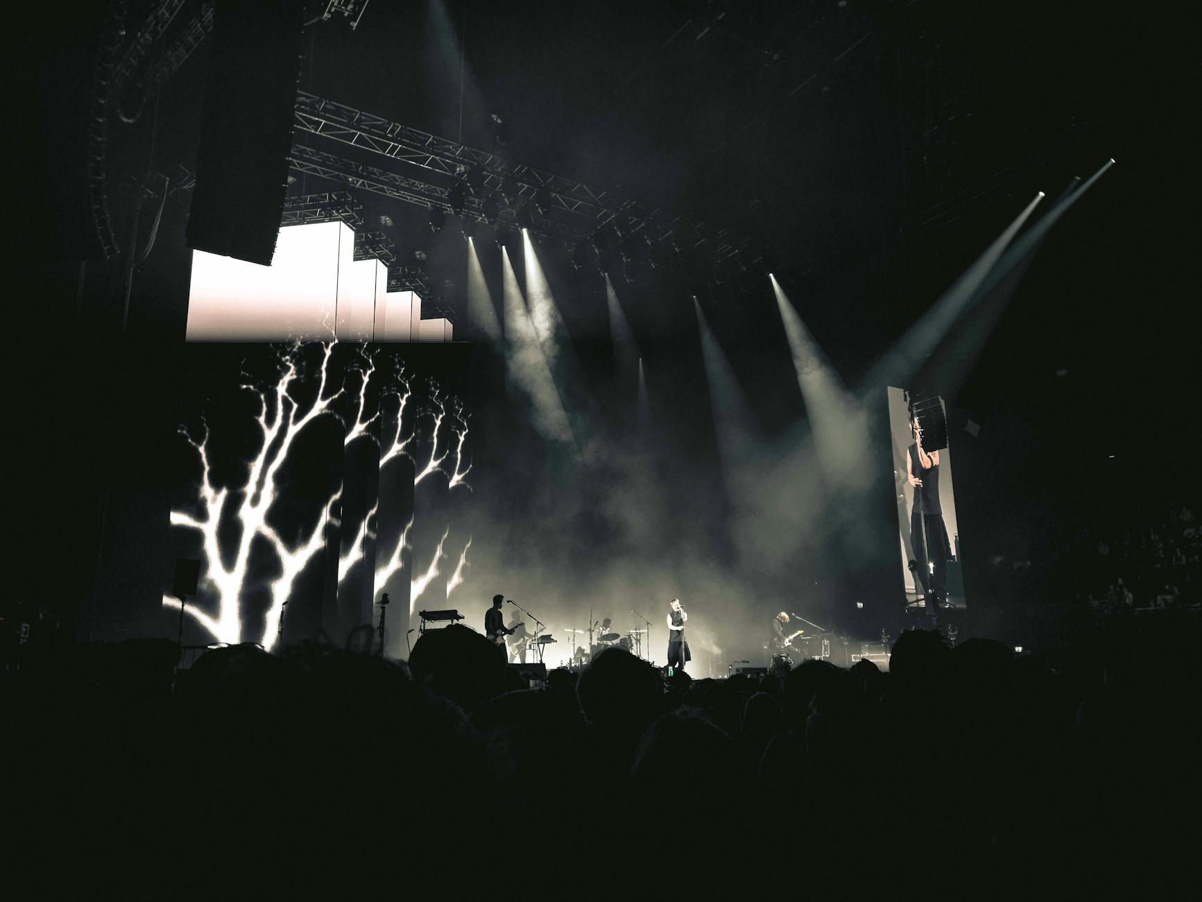 Colorful stage lighting setup with purple and blue spotlights in concert venue