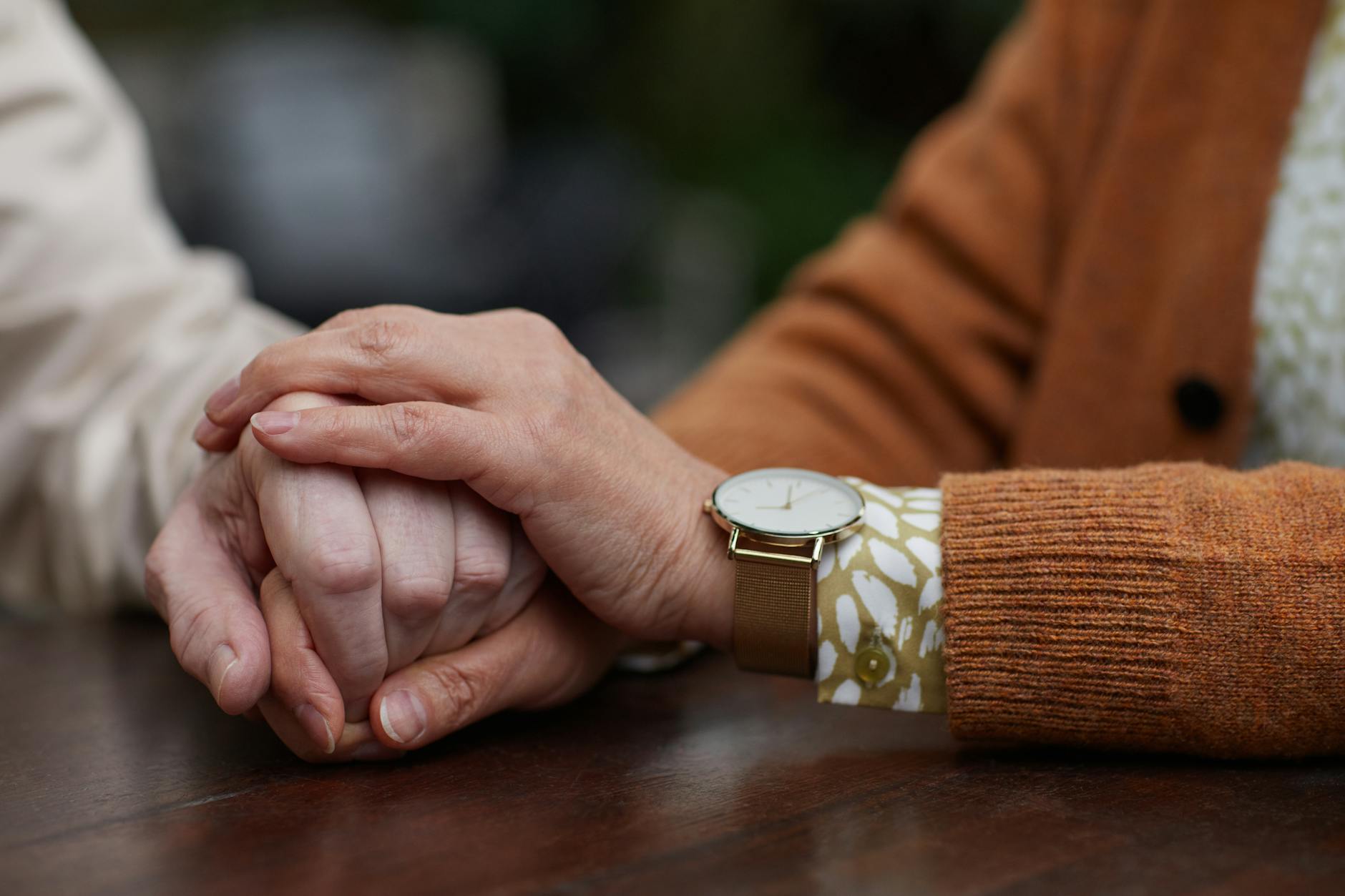 Engaged couple holding hands showing connection and emotional support during wedding planning