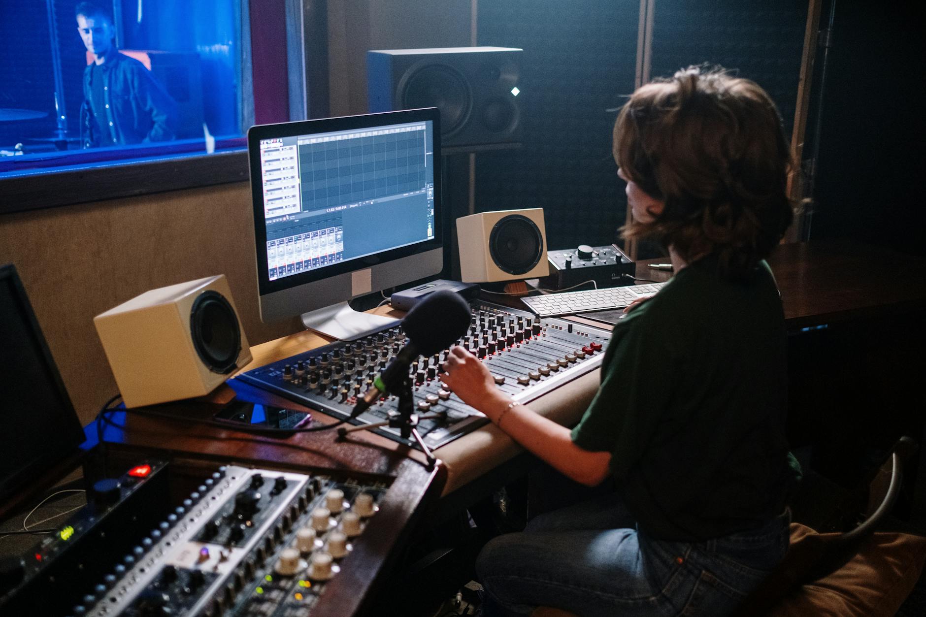 Modern audio recording studio with professional equipment and comfortable seating