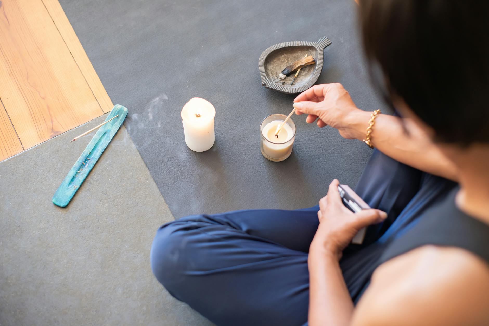 Lit candles creating peaceful ambiance for self-care ritual