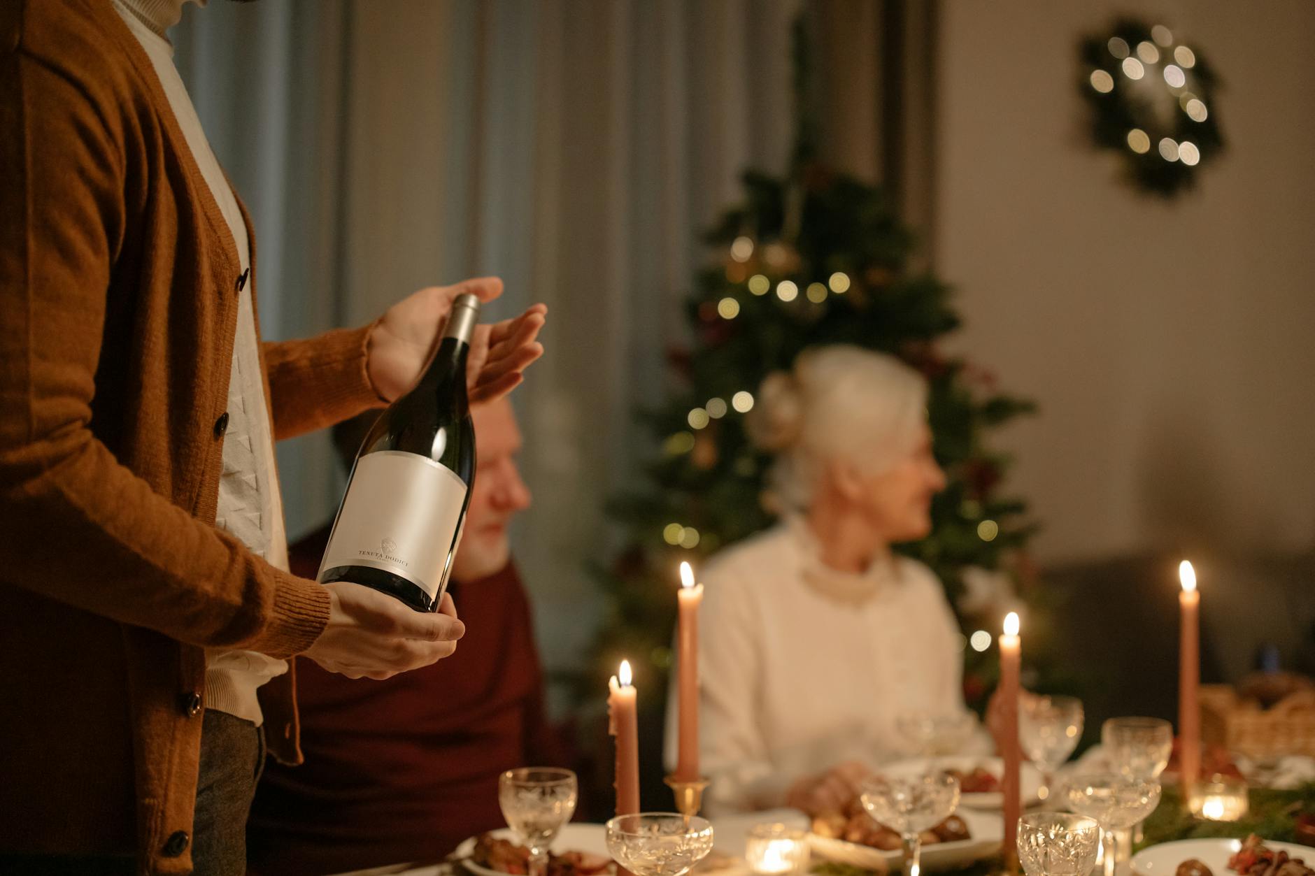 Multi-generational family gathering around an elegant dinner table for celebration