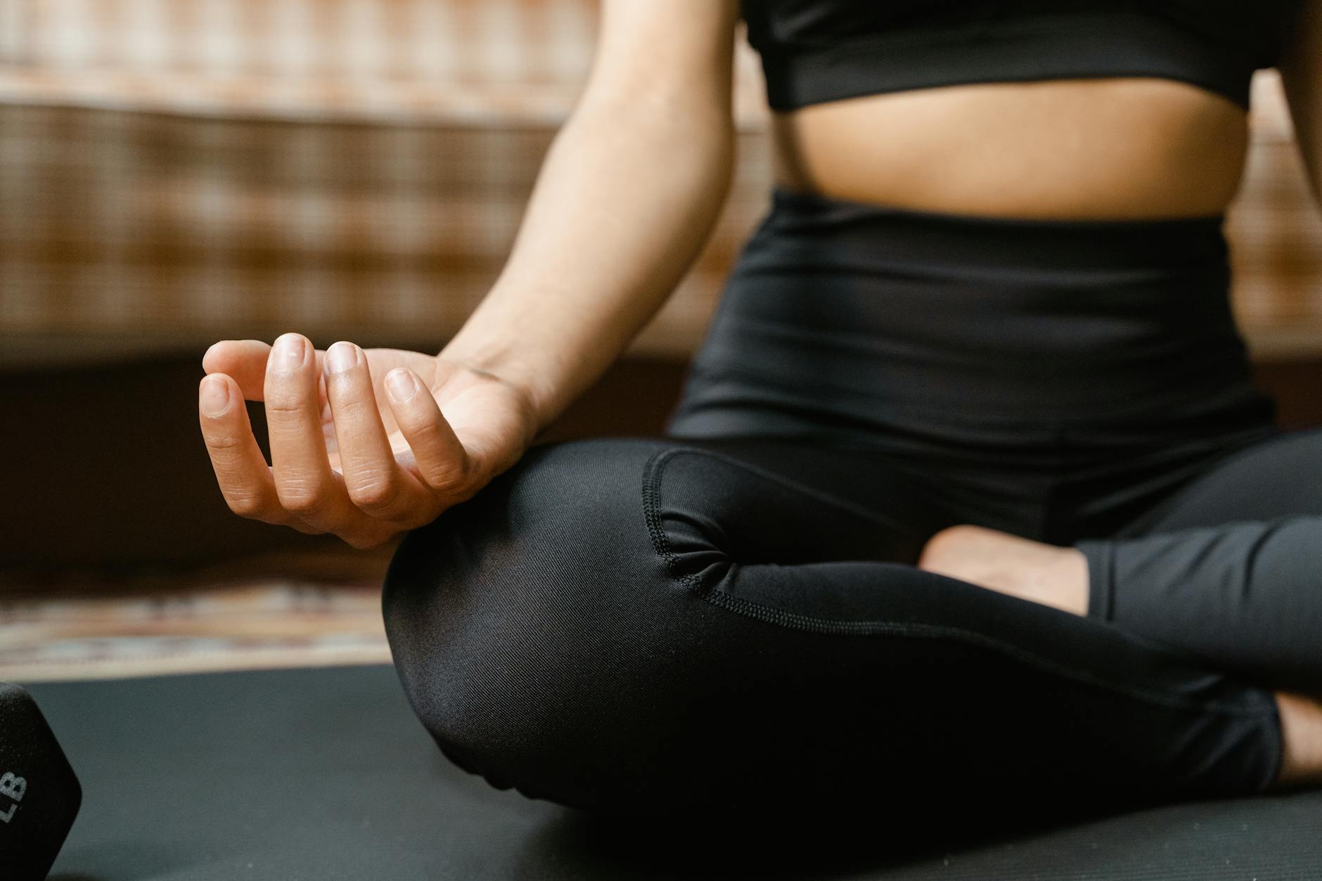 People sitting in meditation pose in modern office wellness space