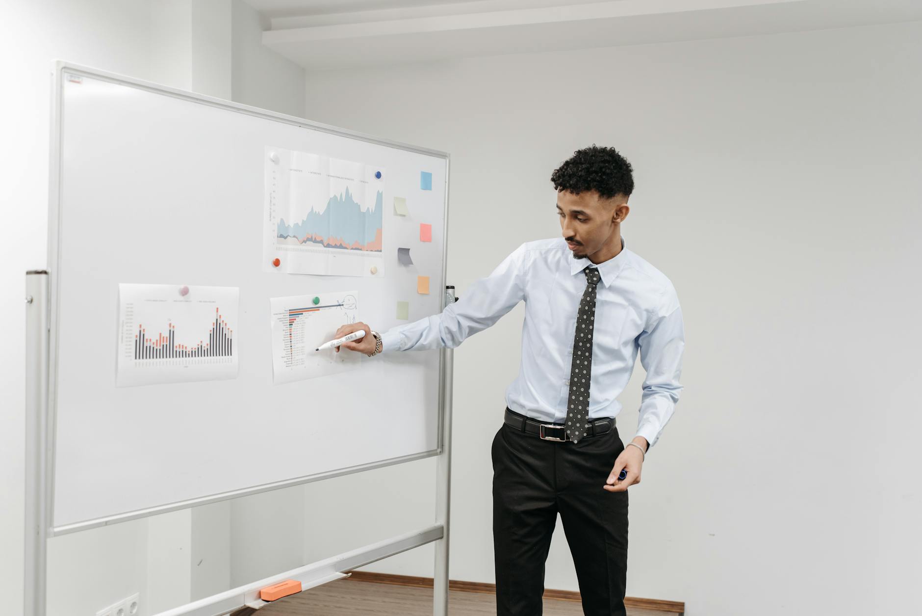Person presenting to colleagues in professional meeting room environment
