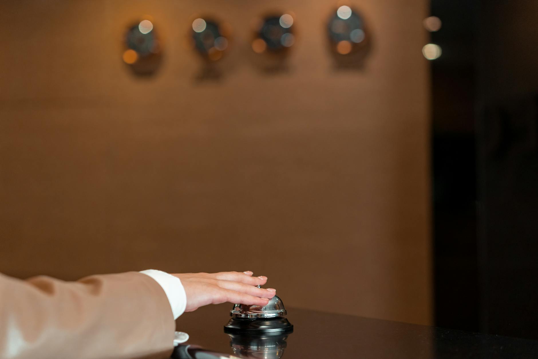 Hotel staff member providing personalized service to guest in luxury hotel setting