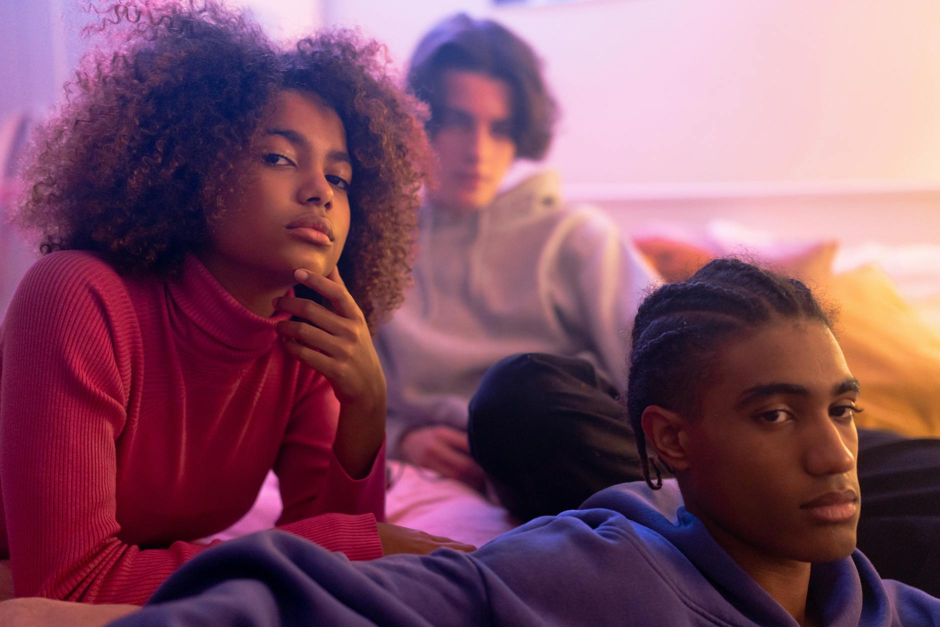 Young adults reading books in comfortable library seating area