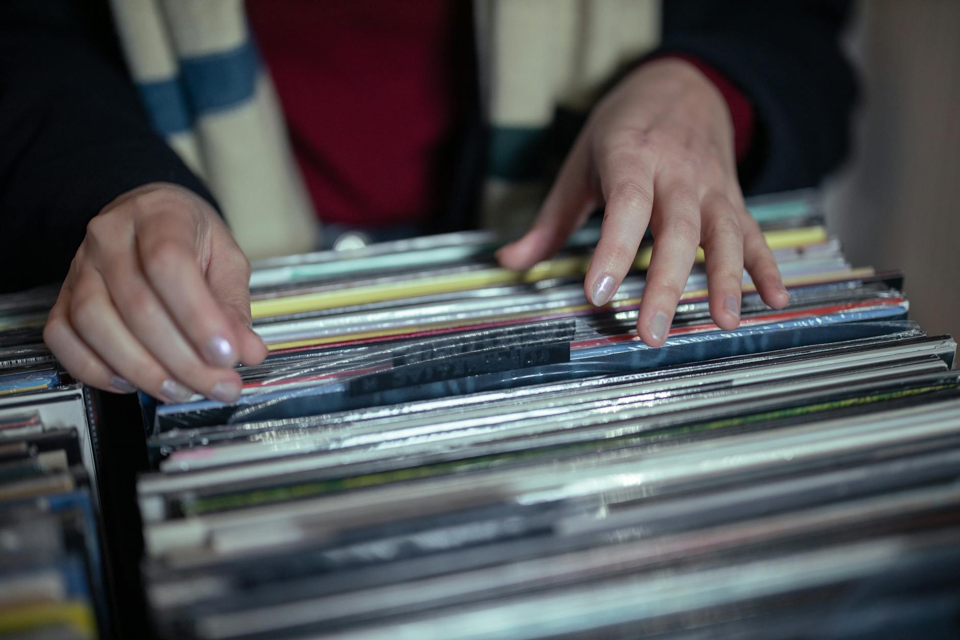 Collection of vinyl records stacked on wooden surface