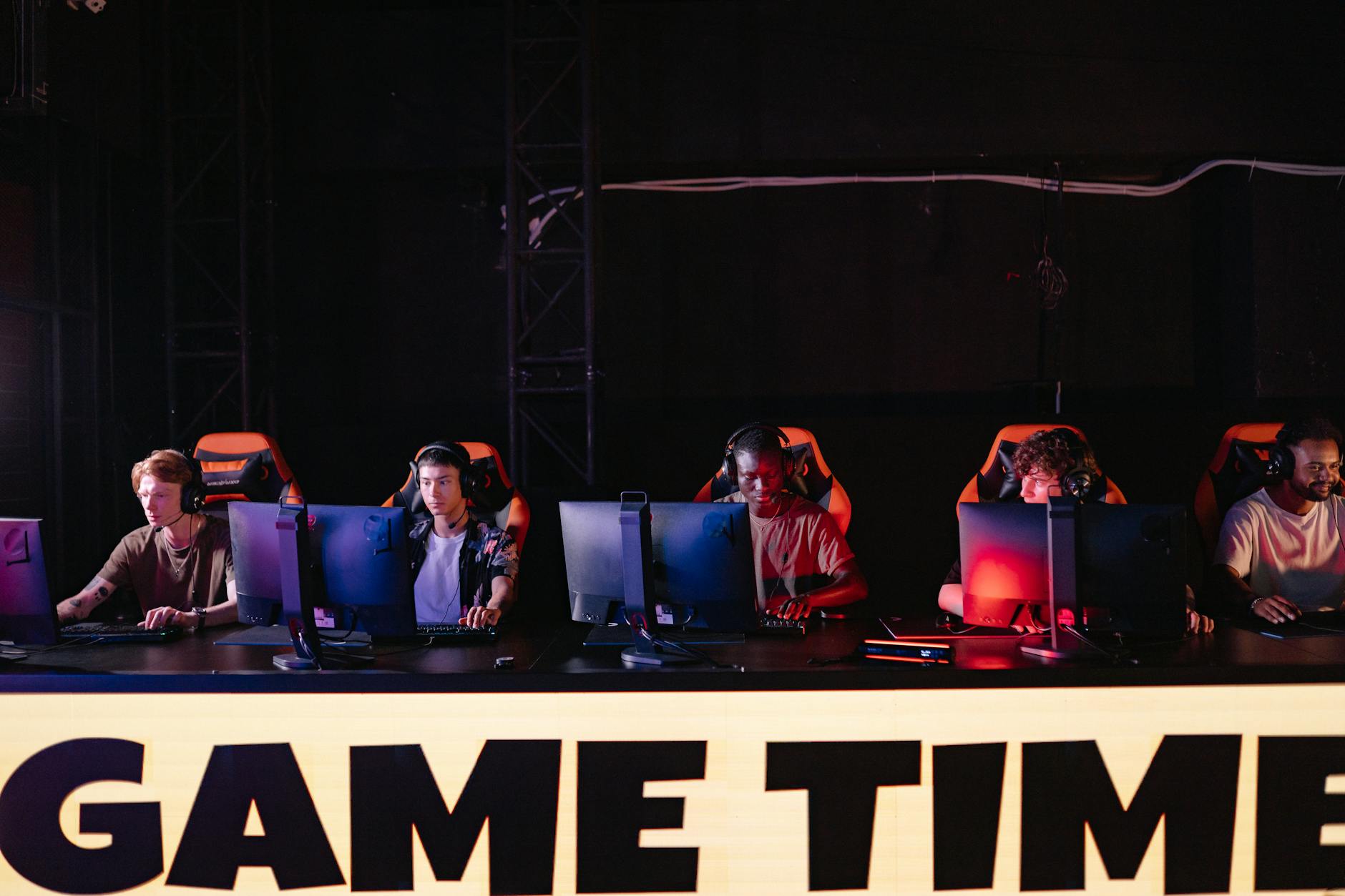 Audience watching competitive gaming event on large screens in venue