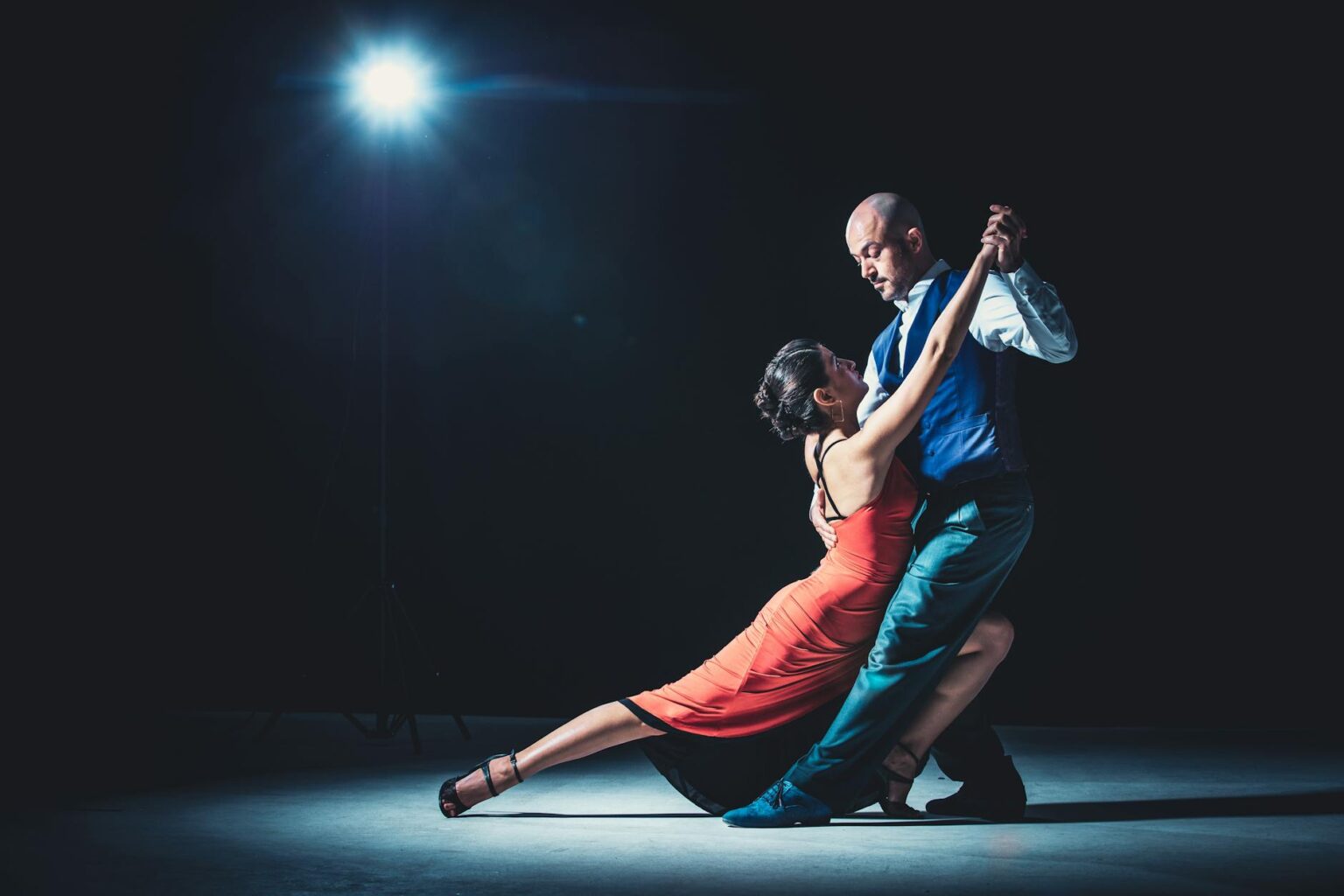 Professional ballroom dancers performing in elegant costumes on stage