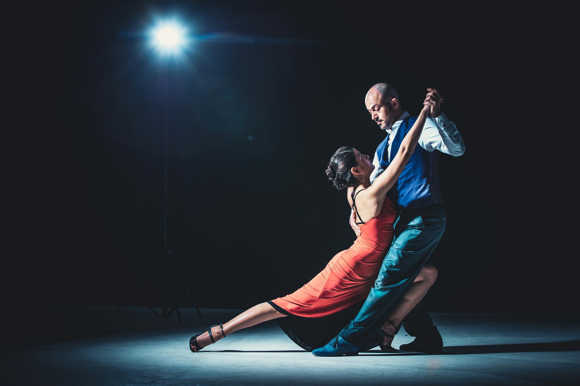 Professional ballroom dancers performing in elegant costumes on stage