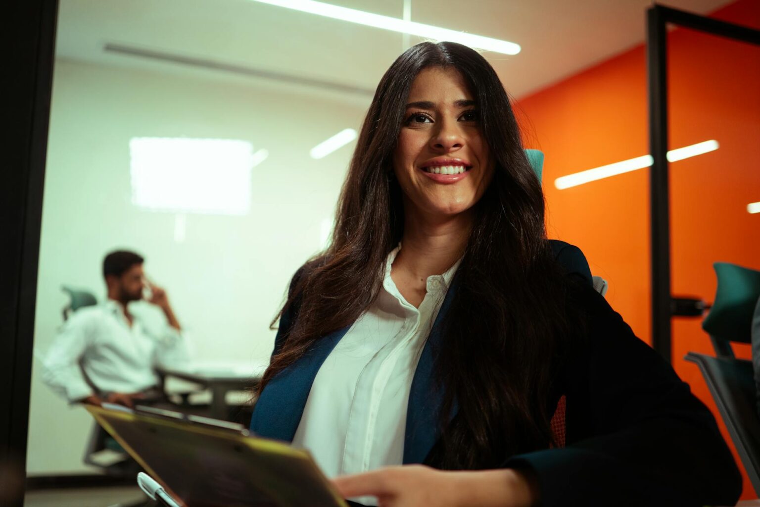 Professional woman sitting at desk in modern office environment